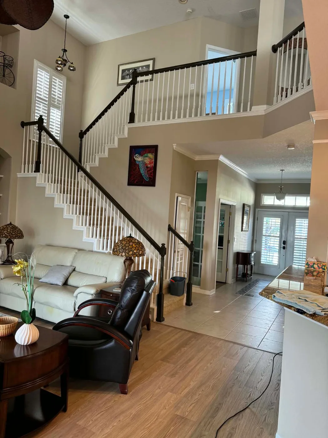 Tidy living room and staircase after a house cleaning in Tampa, FL